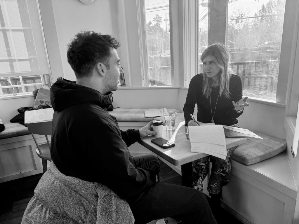 Lisa Cooper of Harmonious Healing Discussing Integrated Wellness at a Table